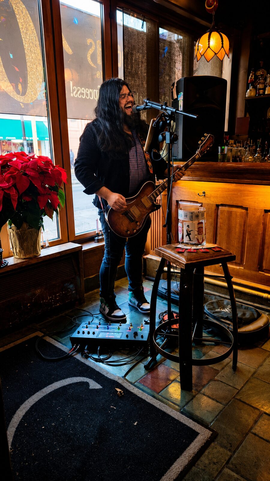Jesse James Armijo performing at a bar venue with warm stage lighting